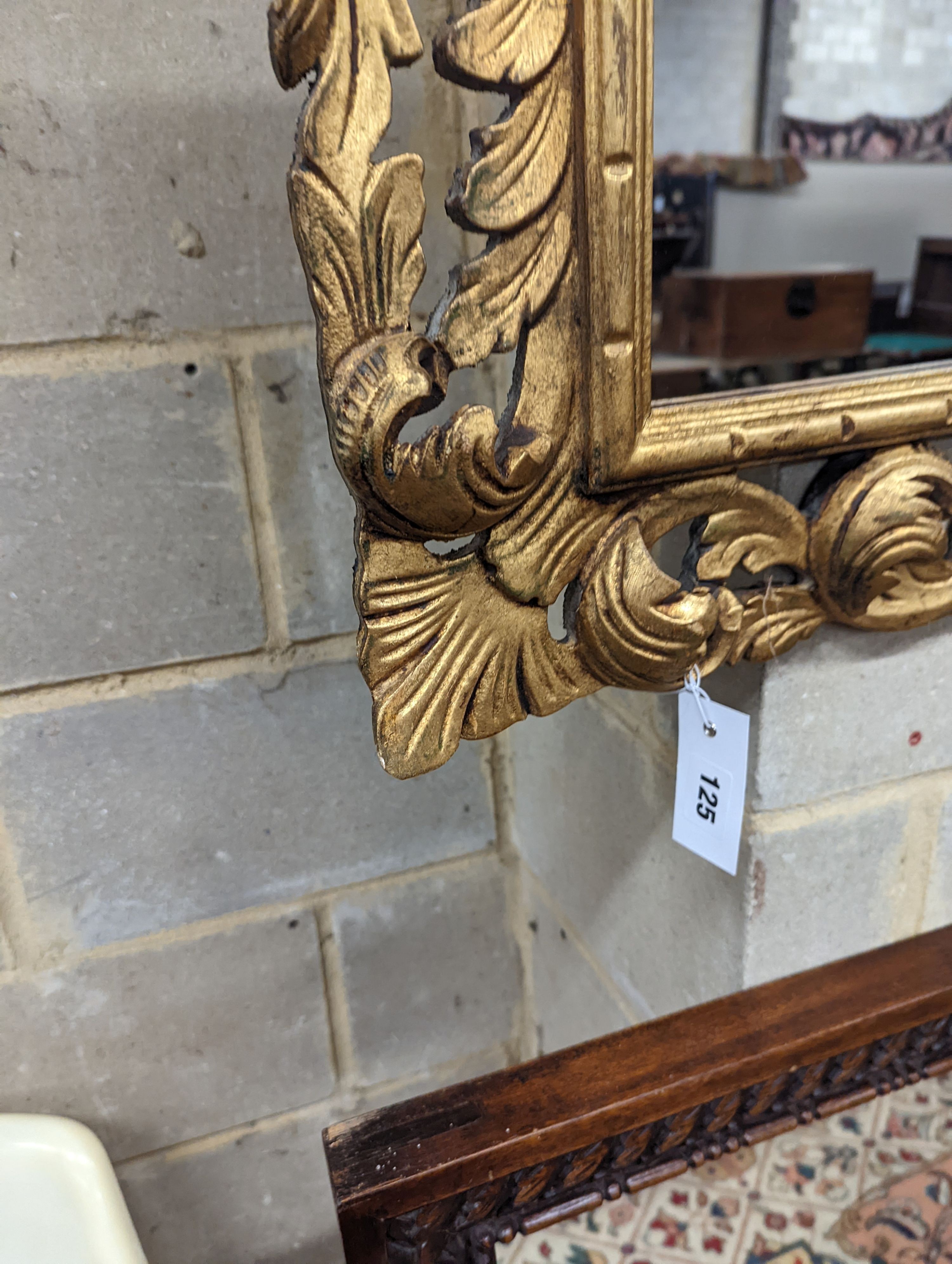 A Florentine style carved giltwood wall mirror, width 80cm, height 70cm